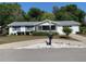 Charming single-story home with well-maintained landscaping and a front yard with mature trees at 11445 Sw 84Th Avenue Rd, Ocala, FL 34481