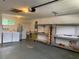 Functional garage with washer, dryer, shelves, and workbench, perfect for projects at 11445 Sw 84Th Avenue Rd, Ocala, FL 34481