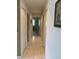 Hallway with tile flooring leading to bedrooms and bathrooms with convenient built-in storage cabinets at 11445 Sw 84Th Avenue Rd, Ocala, FL 34481