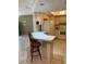 Open-concept kitchen with a breakfast bar, tile flooring, and access to living area at 11445 Sw 84Th Avenue Rd, Ocala, FL 34481