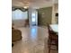 Comfortable living room with tiled floors, a view of the kitchen bar, and a large window at 11445 Sw 84Th Avenue Rd, Ocala, FL 34481