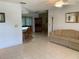 Comfortable living space with tiled flooring, a ceiling fan, and a view of the adjacent dining area at 11445 Sw 84Th Avenue Rd, Ocala, FL 34481