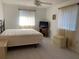 Spacious main bedroom with bed, TV, ceiling fan and natural light from windows at 11445 Sw 84Th Avenue Rd, Ocala, FL 34481