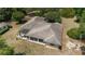 Aerial view showcases a home with large windows, a covered patio, and a well-maintained roof at 11447 Sw 128Th Ave, Dunnellon, FL 34432