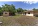 The backyard includes an outbuilding, grassy area, and the home's rear exterior at 11447 Sw 128Th Ave, Dunnellon, FL 34432