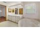 Bright bathroom features a tub, large mirror, and a vanity with cabinets at 11447 Sw 128Th Ave, Dunnellon, FL 34432