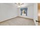 Cozy bedroom with carpet, ceiling fan and a window, creating a comfortable space at 11447 Sw 128Th Ave, Dunnellon, FL 34432
