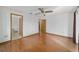 Bedroom with wood floors, neutral paint, and access to an ensuite bathroom at 11447 Sw 128Th Ave, Dunnellon, FL 34432