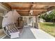 Cozy covered patio features a porch swing, ceiling fan, and view of the spacious backyard at 11447 Sw 128Th Ave, Dunnellon, FL 34432