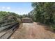 Long driveway leading to a two-car garage, surrounded by mature trees at 11447 Sw 128Th Ave, Dunnellon, FL 34432