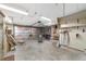 Spacious garage featuring built-in shelving and a large insulated garage door, providing ample storage and utility space at 11447 Sw 128Th Ave, Dunnellon, FL 34432