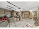 Large garage with an array of shelves, storage and work space, illuminated by bright lighting for various projects and storage at 11447 Sw 128Th Ave, Dunnellon, FL 34432
