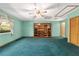 Spacious living room with unique built-in shelving and a ceiling fan at 11447 Sw 128Th Ave, Dunnellon, FL 34432