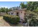 Shed exterior featuring decorative accents and trim, complemented by lush shrubbery and a tranquil outdoor setting at 11447 Sw 128Th Ave, Dunnellon, FL 34432