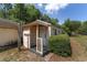 A shed featuring a covered entrance and well-maintained landscaping, adding charm and functionality to the outdoor space at 11447 Sw 128Th Ave, Dunnellon, FL 34432