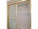 Bathroom shower with glass doors and tiled walls at 11447 Sw 128Th Ave, Dunnellon, FL 34432