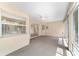 Bright sunroom with large windows offering plenty of natural light and neutral carpeting at 11447 Sw 128Th Ave, Dunnellon, FL 34432