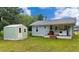 Backyard featuring a shed, ample green space, and a porch area, ideal for outdoor activities at 116 Nw 17Th Pl, Ocala, FL 34475