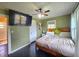 Bright bedroom with ceiling fan, TV and large windows, creating a comfortable living space at 116 Nw 17Th Pl, Ocala, FL 34475