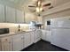 Bright kitchen featuring white cabinets, countertops, and modern appliances, offering a functional cooking space at 116 Nw 17Th Pl, Ocala, FL 34475