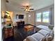 Inviting living room with dark hardwood floors, ceiling fan, and large windows for natural light at 116 Nw 17Th Pl, Ocala, FL 34475