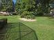 Lush backyard with manicured lawn, mature landscaping, and a peaceful, private setting with shade at 11651 Sw 77Th Cir, Ocala, FL 34476