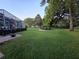 Expansive backyard with well-maintained lawn, barbecue area, and peaceful surroundings near the lanai at 11651 Sw 77Th Cir, Ocala, FL 34476