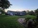 Spacious backyard featuring a screened-in pool, lush lawn, and manicured hedges at 11651 Sw 77Th Cir, Ocala, FL 34476