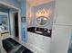 Bright bathroom featuring a vanity with a black countertop and a decorative oval mirror at 11651 Sw 77Th Cir, Ocala, FL 34476