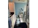 Well-lit bathroom featuring tile floors, white cabinets, and a glass-enclosed shower at 11651 Sw 77Th Cir, Ocala, FL 34476