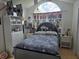 The bedroom has a large arched window and Star Wars themed decor at 11651 Sw 77Th Cir, Ocala, FL 34476