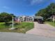 Attractive home showcasing a brick driveway and well-manicured lawn at 11651 Sw 77Th Cir, Ocala, FL 34476