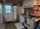 Functional garage space equipped with a workbench, storage cabinets, and ample shelving at 11651 Sw 77Th Cir, Ocala, FL 34476