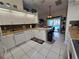Bright kitchen features bar stool seating with views to the pool area at 11651 Sw 77Th Cir, Ocala, FL 34476