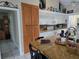 Bright kitchen with white cabinets and a breakfast bar at 11651 Sw 77Th Cir, Ocala, FL 34476