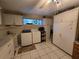This large laundry room features tile floors, cabinets, and a sink at 11651 Sw 77Th Cir, Ocala, FL 34476