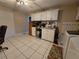 Spacious laundry room offers ample storage with white cabinets and tiled flooring at 11651 Sw 77Th Cir, Ocala, FL 34476