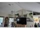 Bright living room boasts a ceiling fan and decor shelves above the television, adding charm to the space at 11651 Sw 77Th Cir, Ocala, FL 34476