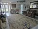 Bright living room featuring tile flooring, furniture, and a front door view at 11651 Sw 77Th Cir, Ocala, FL 34476