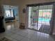 View into the kitchen and the screened-in pool from the living room at 11651 Sw 77Th Cir, Ocala, FL 34476