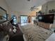 Cozy living room with tile flooring and a modern ceiling fan, offers pool views from sliding glass doors at 11651 Sw 77Th Cir, Ocala, FL 34476