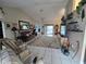 Spacious living room offers tile flooring and a plush rug, creating a comfortable and inviting atmosphere at 11651 Sw 77Th Cir, Ocala, FL 34476