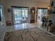 Living room with tile floor, view to pool and Star Wars Yoda statue at 11651 Sw 77Th Cir, Ocala, FL 34476