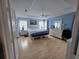 Serene bedroom with light blue walls, wood floors, and ample natural light at 11651 Sw 77Th Cir, Ocala, FL 34476