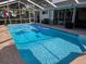 Screened-in in-ground pool surrounded by brick paver patio is perfect for outdoor enjoyment at 11651 Sw 77Th Cir, Ocala, FL 34476