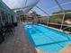 Beautiful screened in-ground pool with outdoor seating is perfect for entertaining and relaxation at 11651 Sw 77Th Cir, Ocala, FL 34476