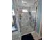 Bathroom featuring a shower with marble-look tile and a seamless glass door at 11651 Sw 77Th Cir, Ocala, FL 34476
