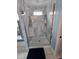 Bathroom featuring a shower with marble-look tile and a seamless glass door at 11651 Sw 77Th Cir, Ocala, FL 34476