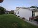 Side view of the home, with vinyl siding, manicured lawn, and a clean, well-kept appearance at 11651 Sw 77Th Cir, Ocala, FL 34476