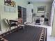 Tiled sunroom features a comfortable sitting area with a TV and access to backyard at 11651 Sw 77Th Cir, Ocala, FL 34476